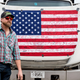 A demonstrator passes an autographed American flag as he prepares to depart Hagerstown Speedway in Hagerstown, Maryland, on March 7, 2022.